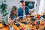 Adult and Student working on robotics project